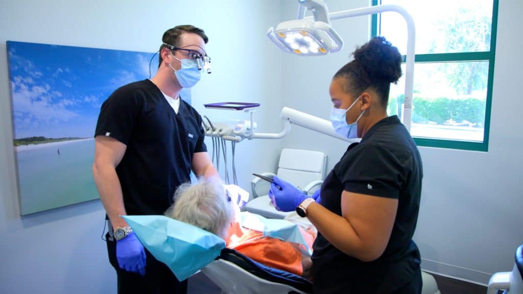 Dr. and hygienist with patient